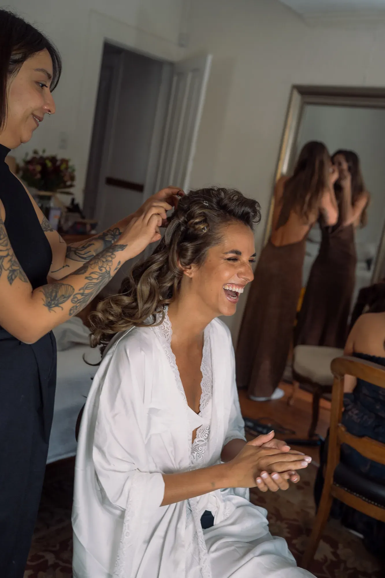 La novia se ríe mientras la peinan